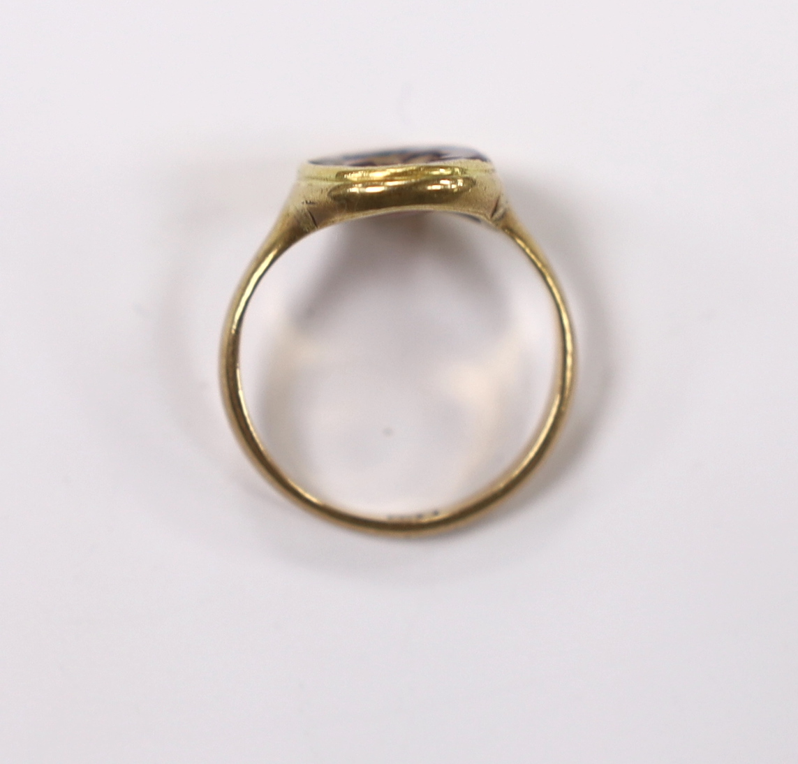 An antique 9ct and intaglio glass? set oval ring, depicting the bust of a Roman soldier to dexter, size P, gross weight 3.8 grams.